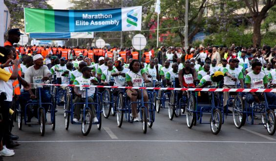 Racer line up at the start of the tri-cycle and wheel chair race during the Standard Chartered Nairobi Marathon 2010